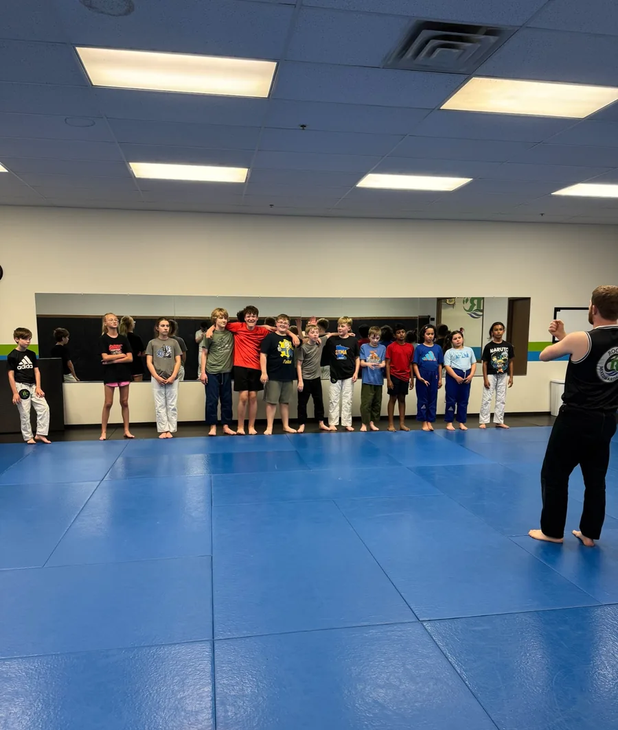 Kids and teens attending a Roots martial arts class